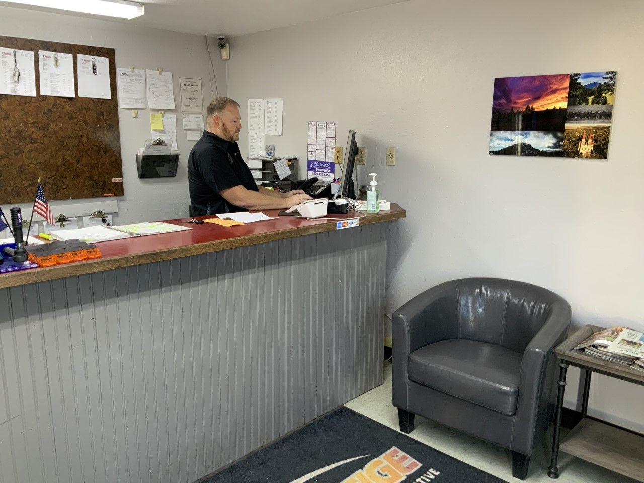 A man is standing at a counter in a waiting room.