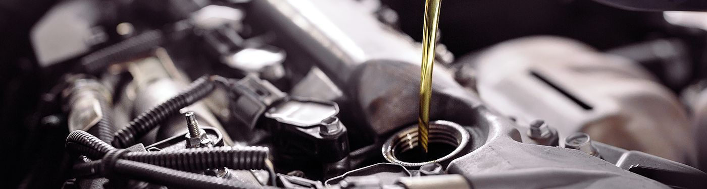 Oil being poured into a car engine.