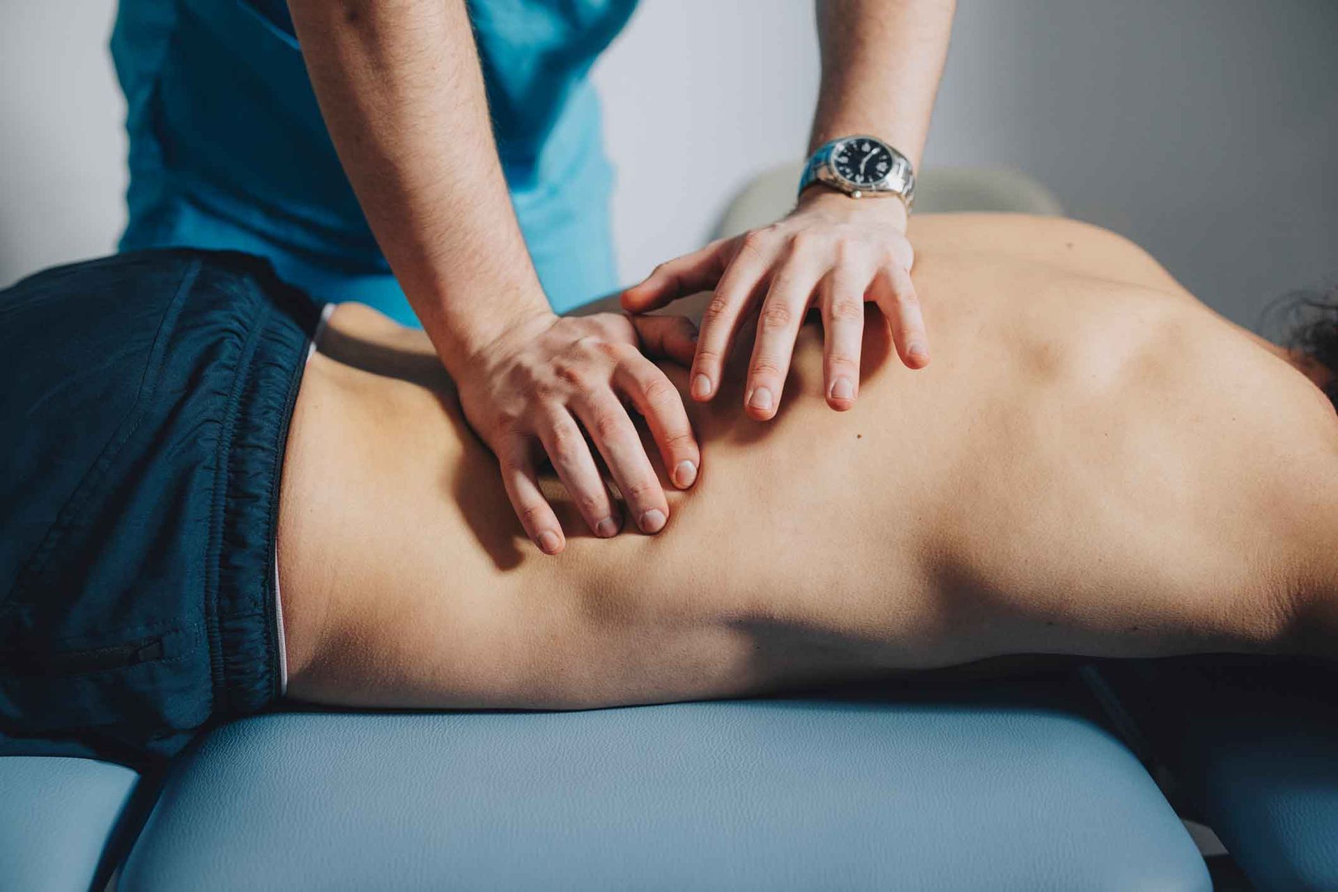 A Man Is Laying On A Table Getting A Massage From A Woman – Dunbar, WV - Smith & Jones Chiropractic