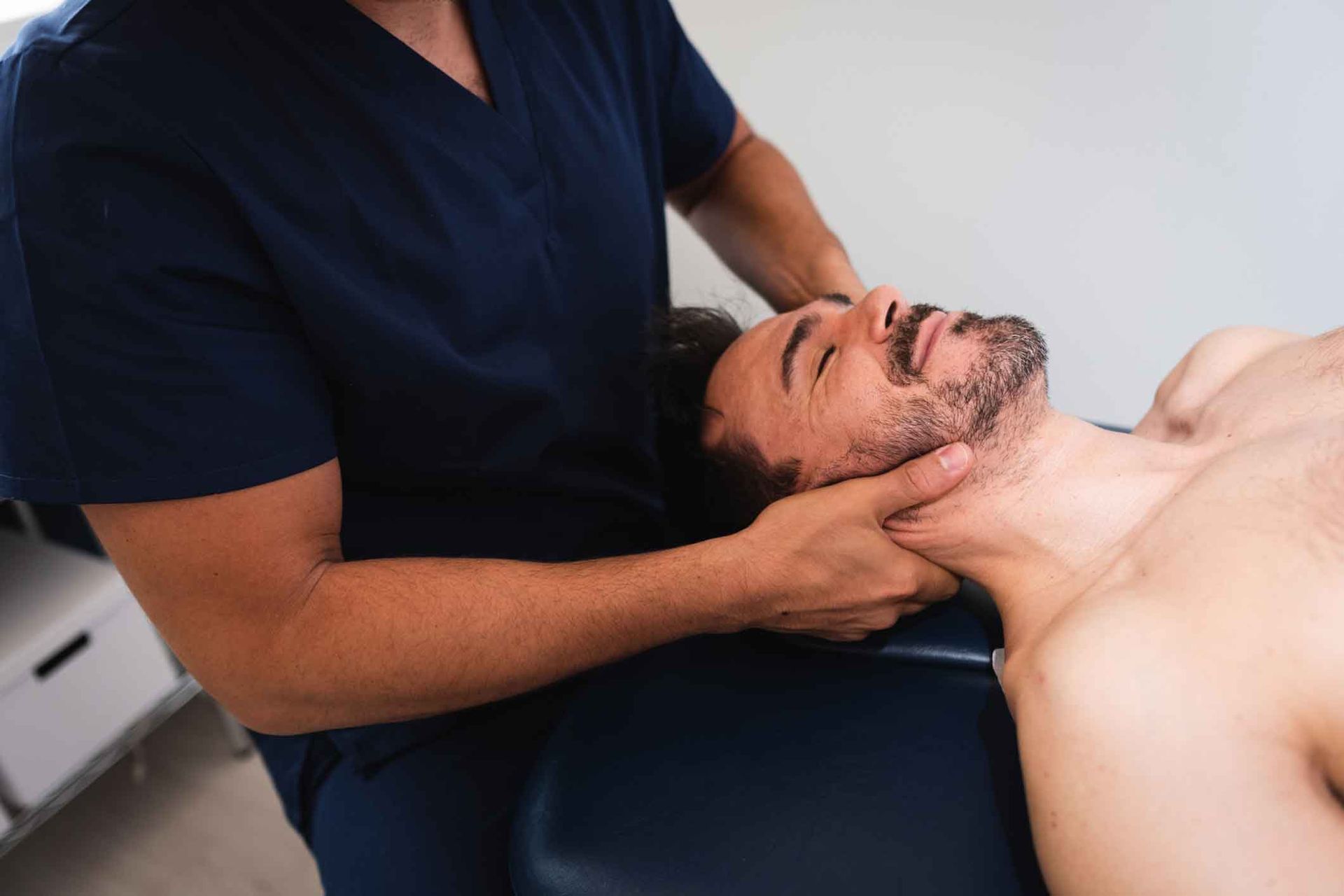 A Man Is Laying On A Table Getting A Massage From A Doctor – Dunbar, WV - Smith & Jones Chiropractic