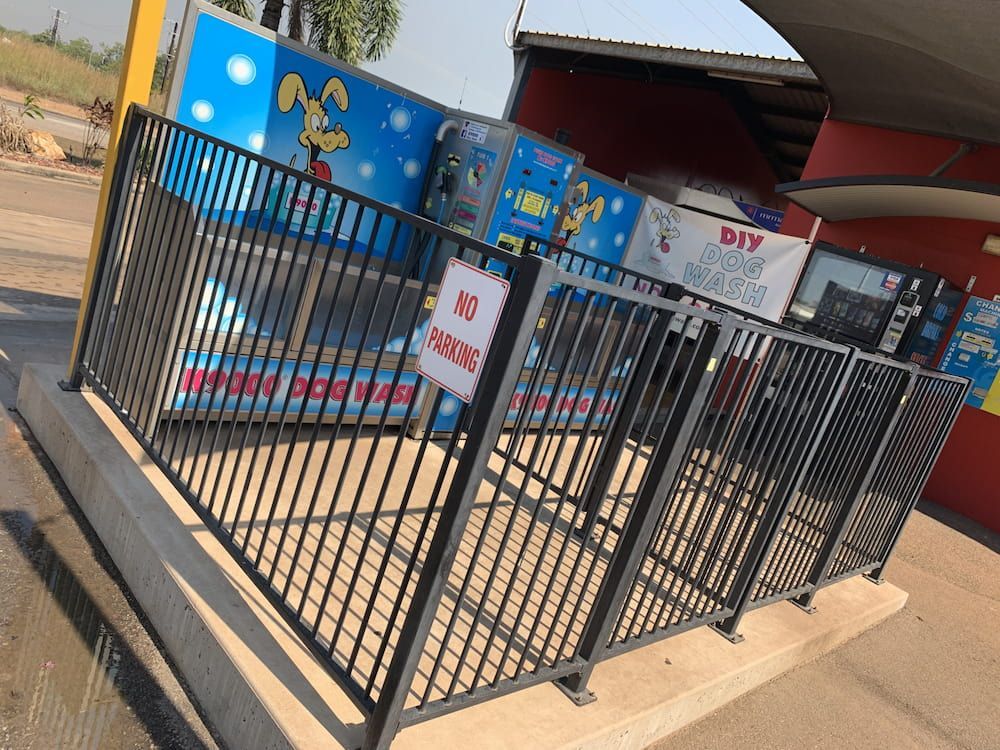 Black Fenced-in Children's Ride With Cartoon Decorations — Ezyas Car Wash NT in Yarrawonga, NT