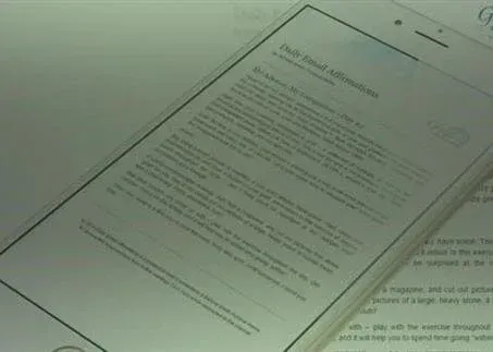A tilted smartphone displaying a text-heavy document on a light-colored surface.