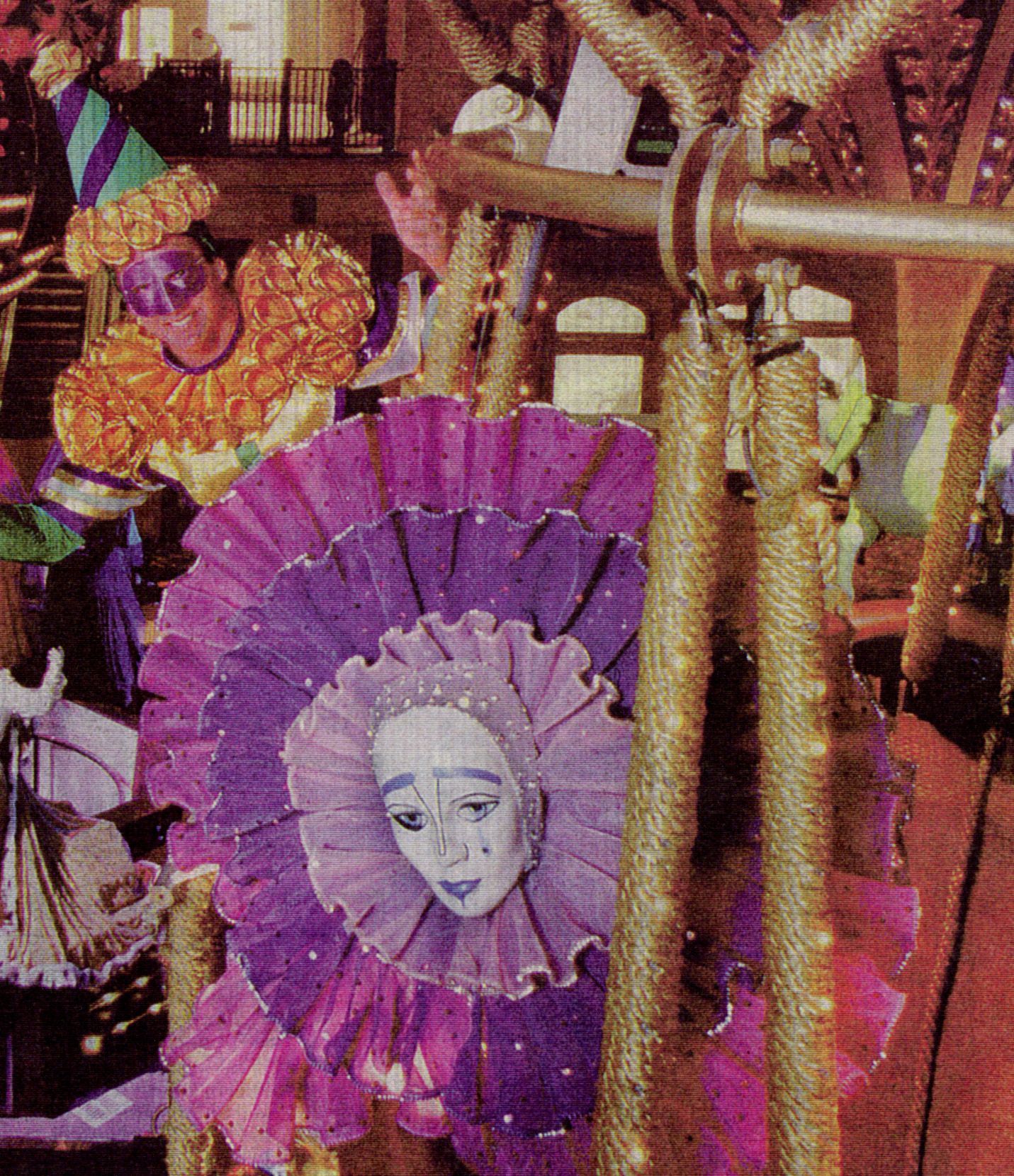 Mardi Gras float decoration with sad-faced mask and jester. Purple, gold, and festive colors.