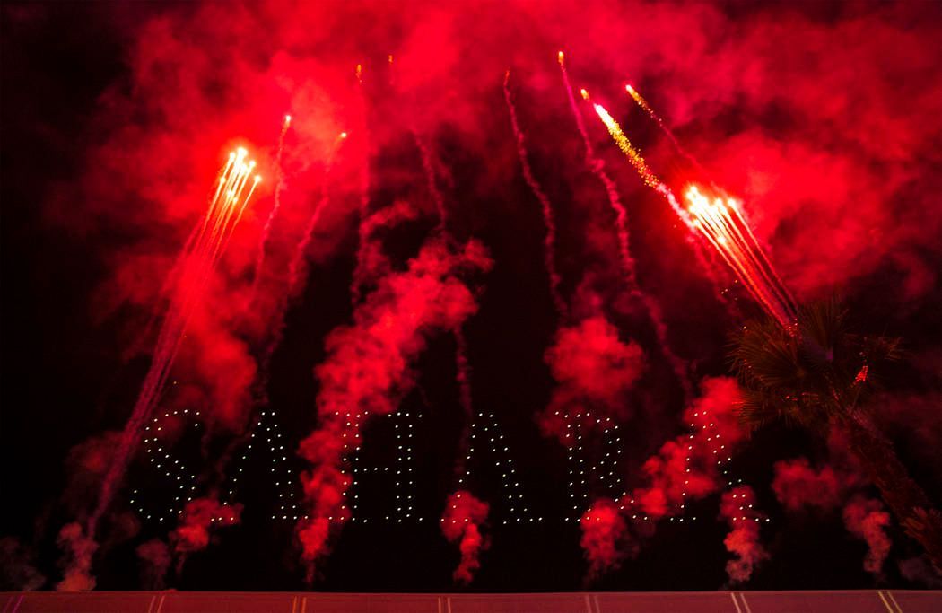 Red fireworks explode, with 