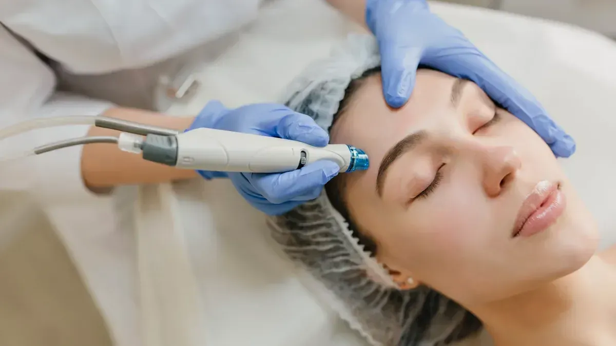 A clinician performing a skin treatment with a handheld device