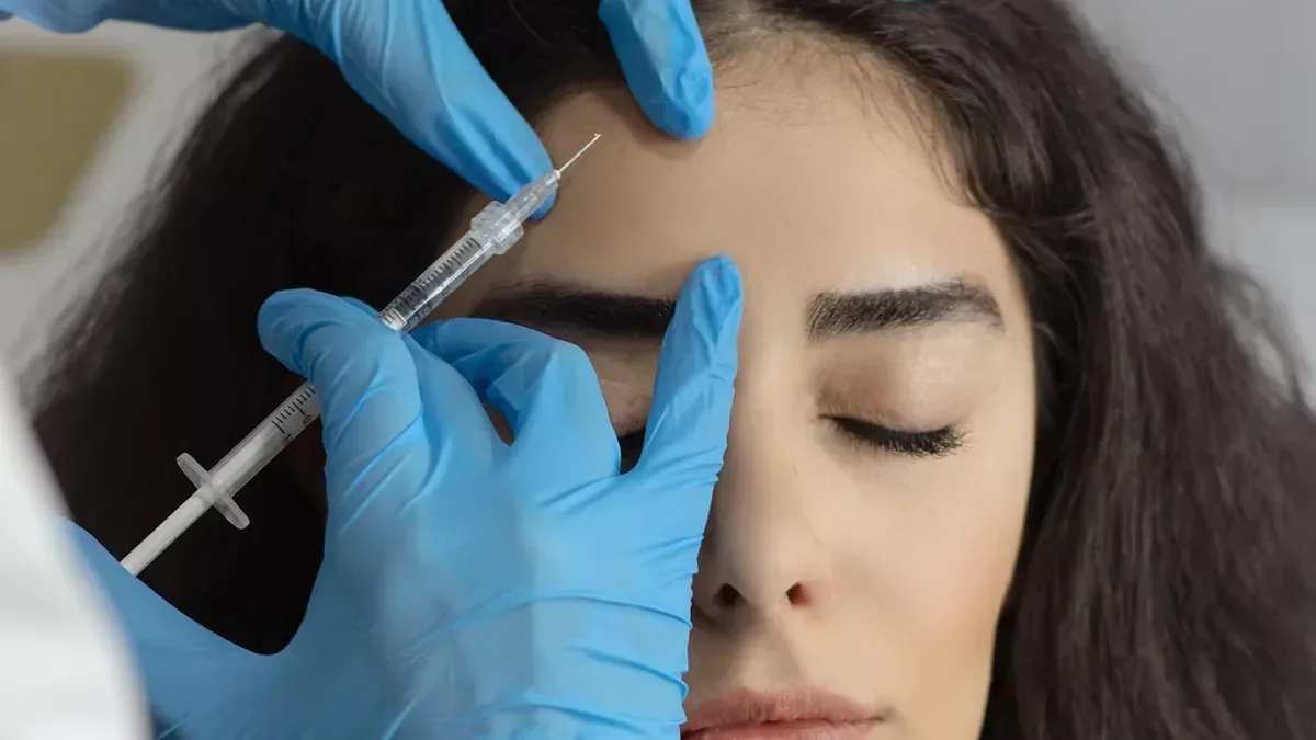 A clinician administering an anti-wrinkle injection