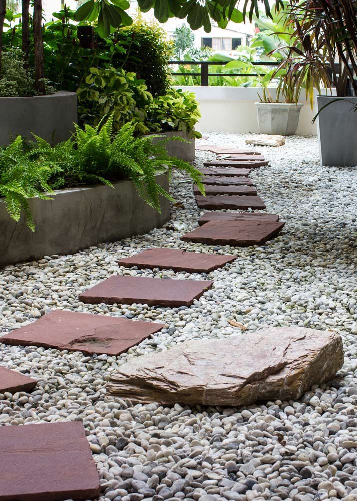 A Stone Walkway Surrounded By Gravel And Plants In A Garden — Serious About Landscape Supplies In Narara, NSW