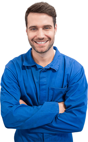 Smiling man in a blue shirt with arms crossed on a white background | S.G. Auto Repair