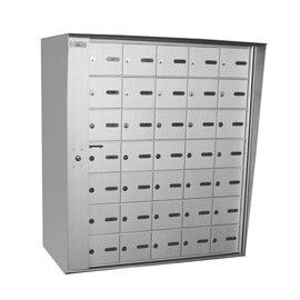 Metal mailboxes with multiple individual compartments in a building.
