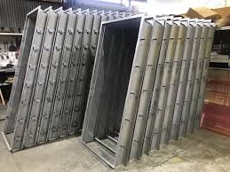 Stacks of rectangular metal door frames.