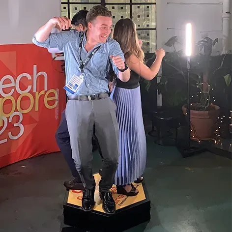 People dancing on a hexagonal platform at a