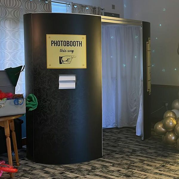 A black portable photobooth with a gold