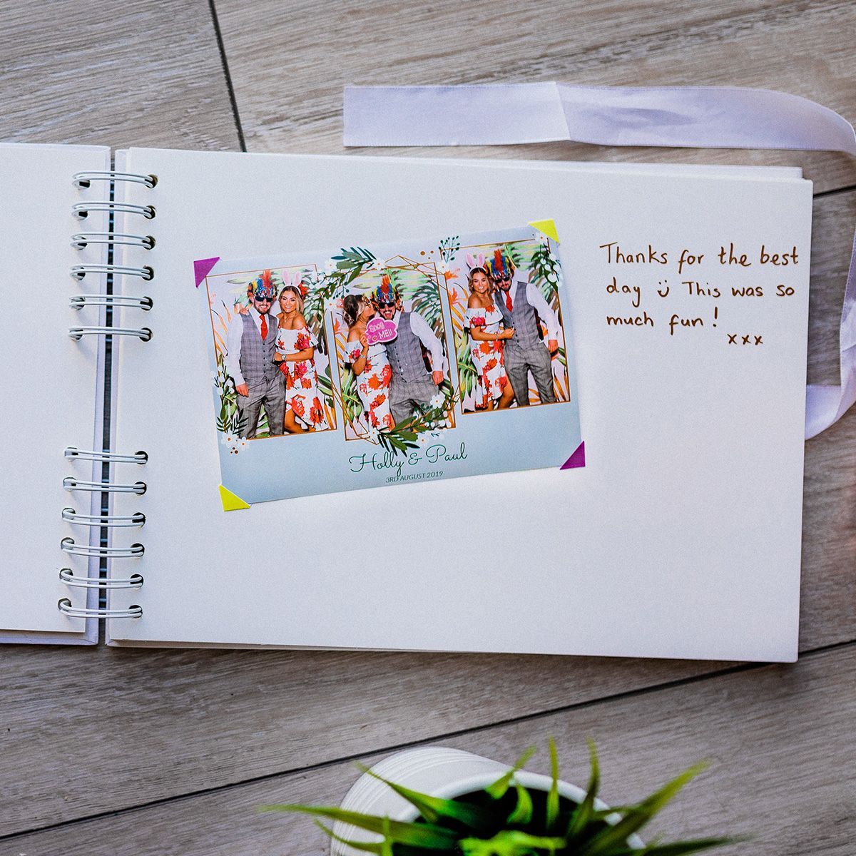 A photo strip in a spiral-bound guestbook with a handwritten note saying,