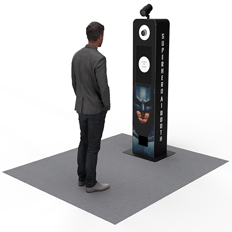 A person stands before a vertical photo booth display featuring Batman imagery and a top-mounted camera on a gray surface.