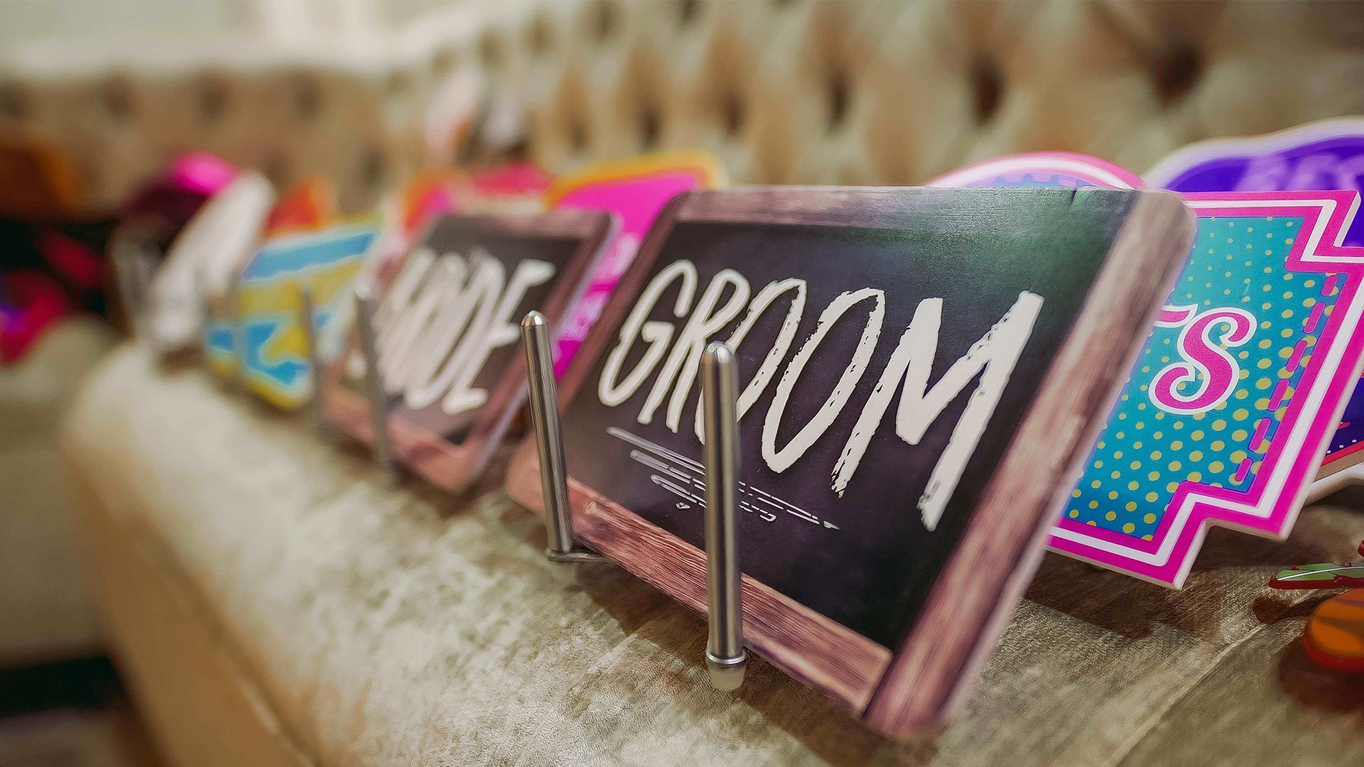 A row of wedding-themed props, including a chalkboard sign labeled 