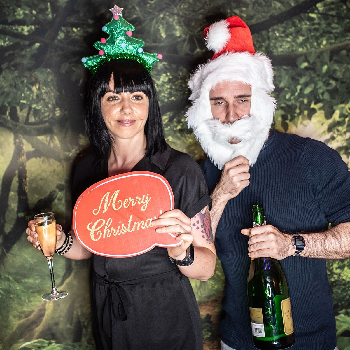 A person in a Christmas tree headband holding a