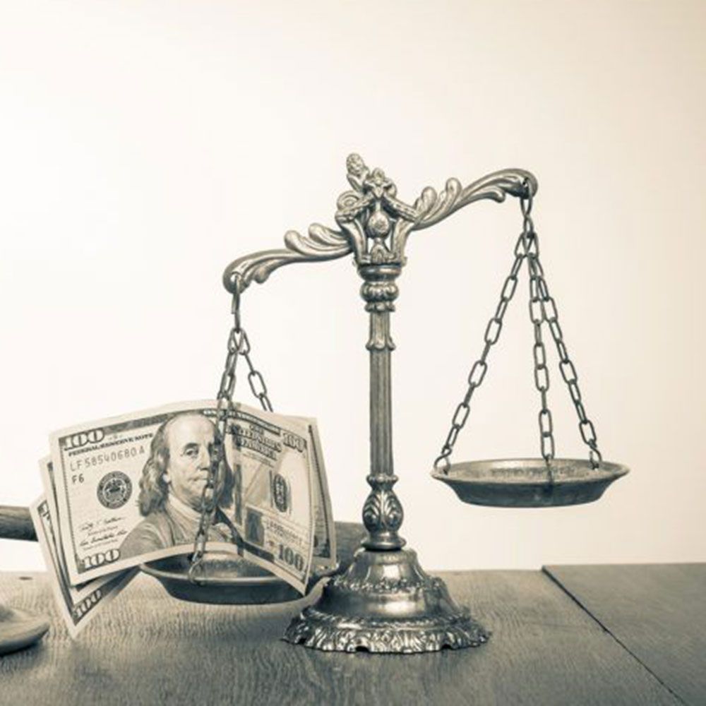 litigation A black and white photo of a scale with money on it
