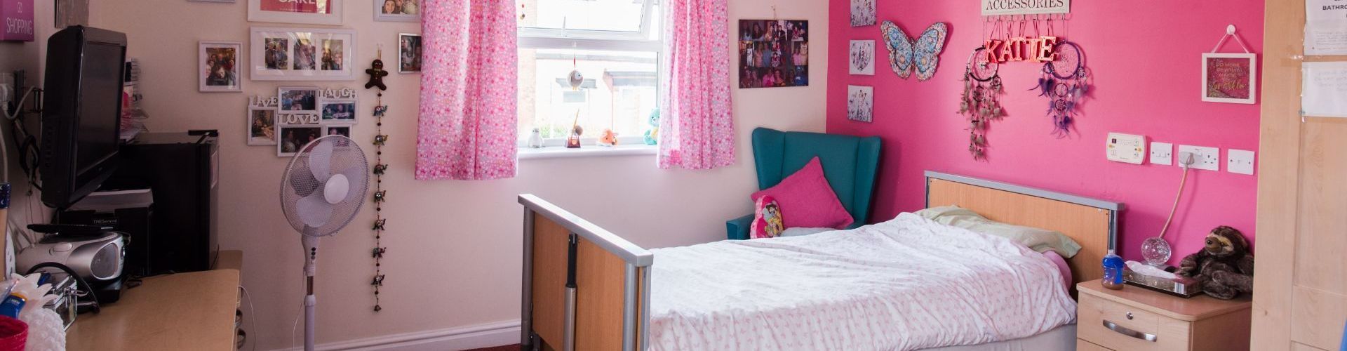 a bedroom with pink walls and a bed