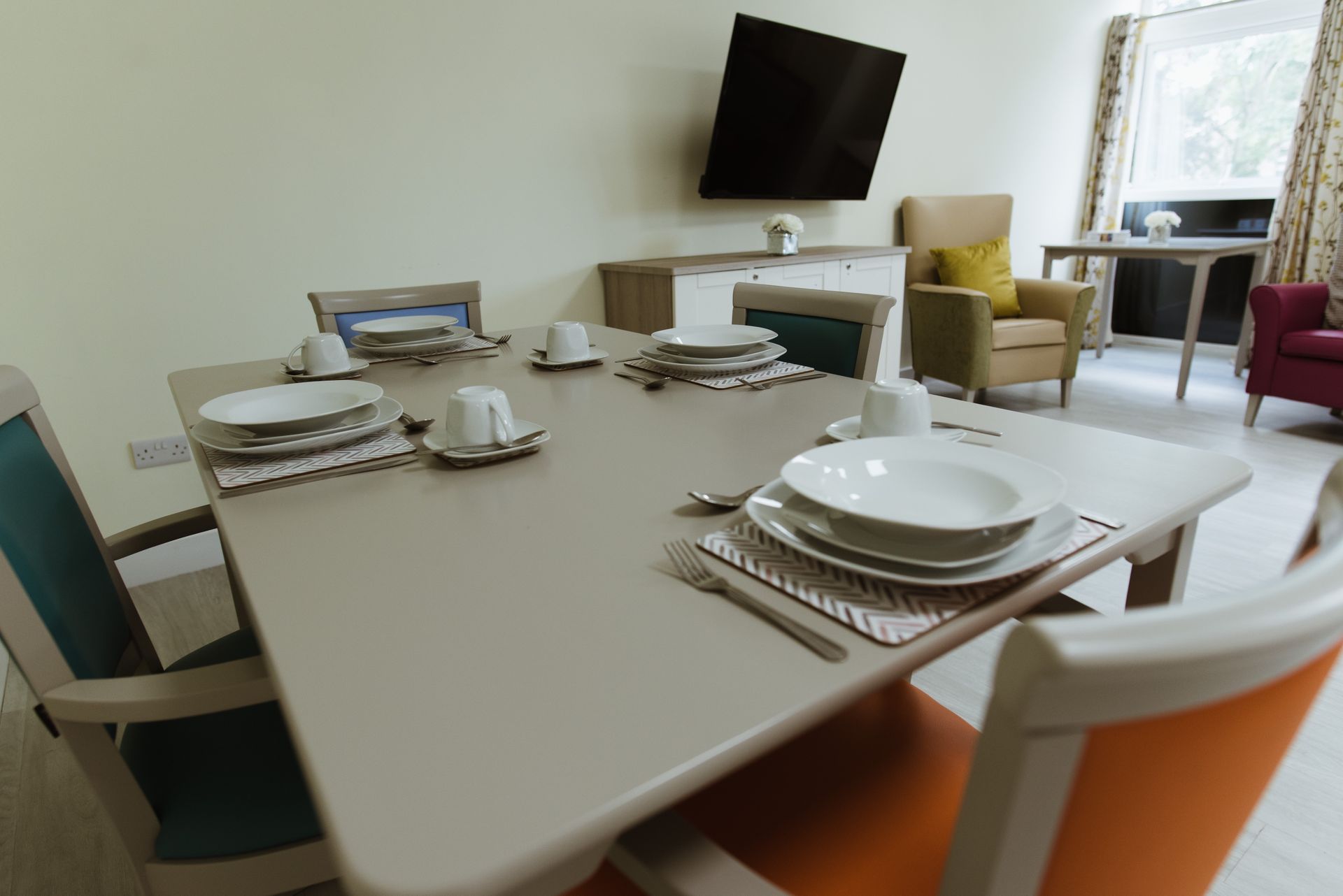 a dining room table with plates and utensils on it