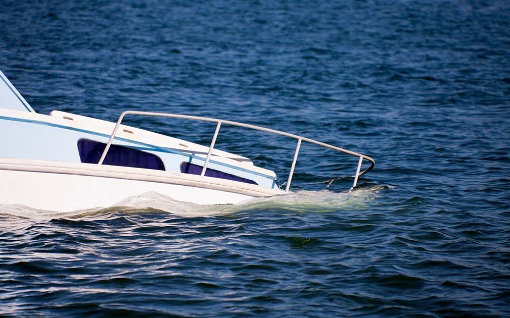 a blue and white boat is floating on the water