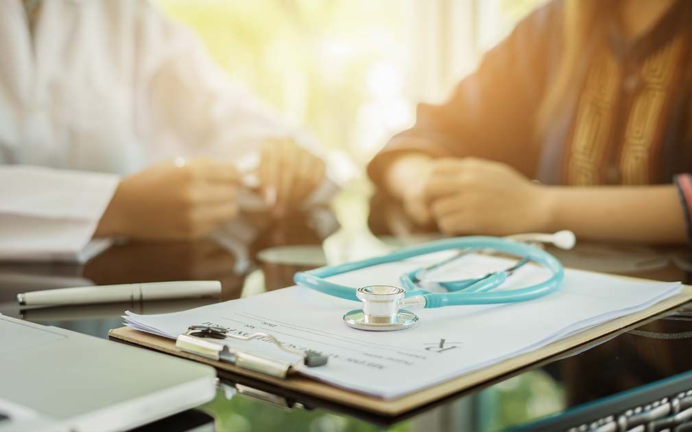 a stethoscope sits on top of a clipboard with a prescription on it