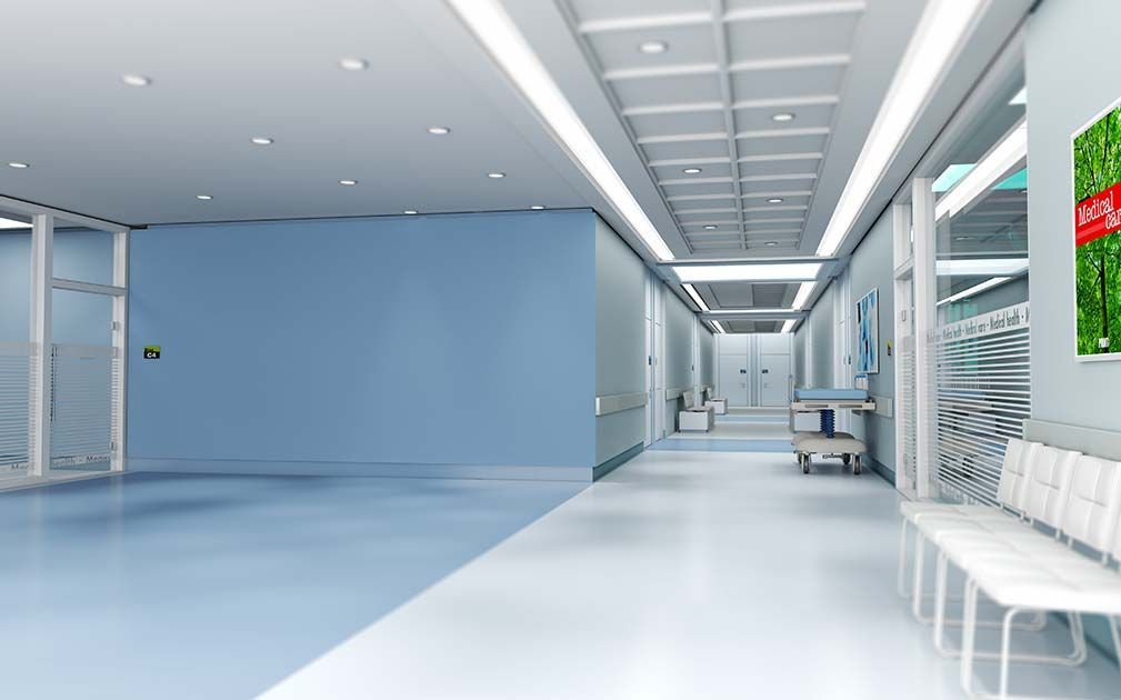 a hospital hallway with a sign on the wall that says waiting