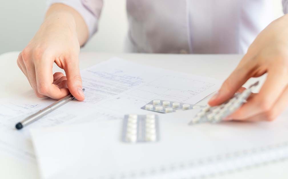 a person is writing on a piece of paper with a pen
