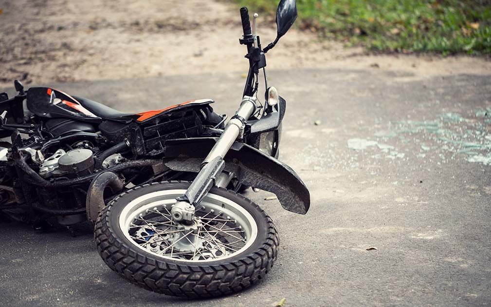a motorcycle is laying on its side on the road