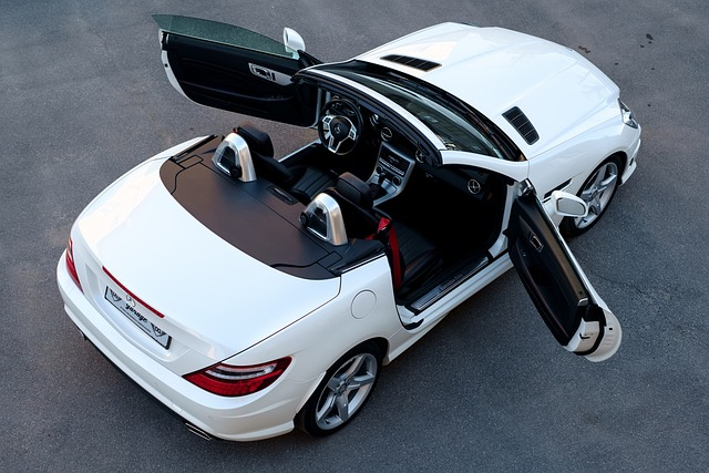 An aerial view of a white sports car with its doors open