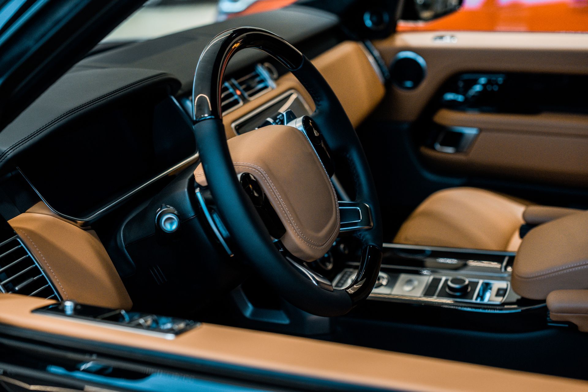 A close up of the interior of a car with a steering wheel.
