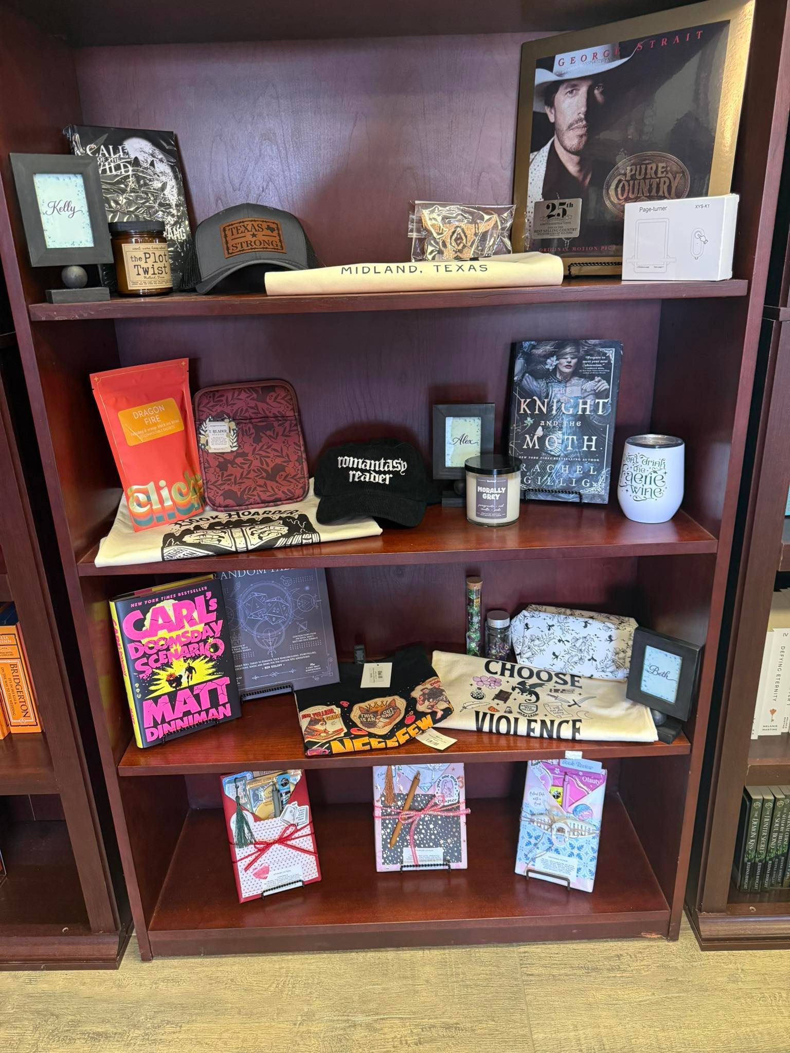 Wooden display shelf with assorted gift items, cards, and decorative boxes in a store.