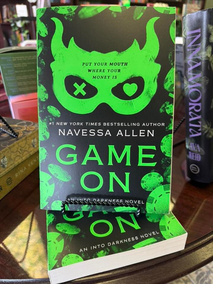 Neon green book cover reading “GAME ON” displayed upright on a shelf