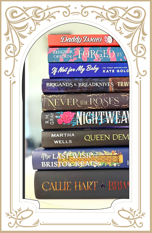 Decorative gold frame around a stack of colorful hardcover books with visible titles inside.