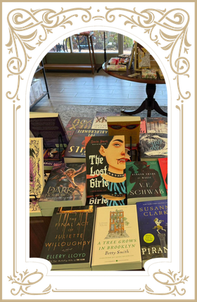 Books and magazines arranged in a decorative display with a portrait cover in the center