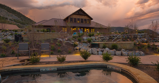 Iron Mountain Hot Springs Building
 with a swimming pool in front of it.