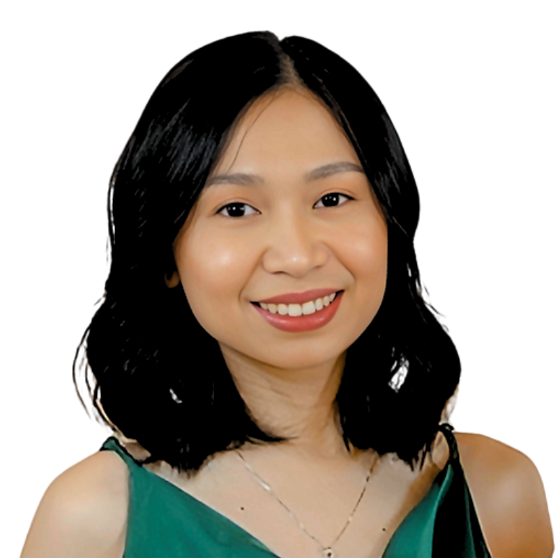 Portrait of a smiling woman with shoulder-length black hair, wearing a green top and necklace on a white background