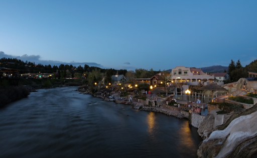 A large body of water surrounded by buildings and trees at night in Pagosa Springs Resort & Spa