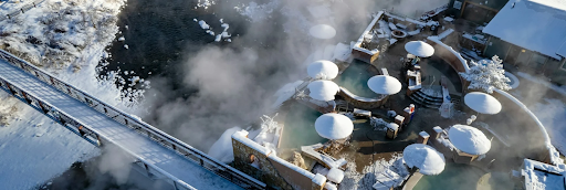An aerial view of a hot spring covered in snow in Pagosa Springs Resort & Spa Colorado