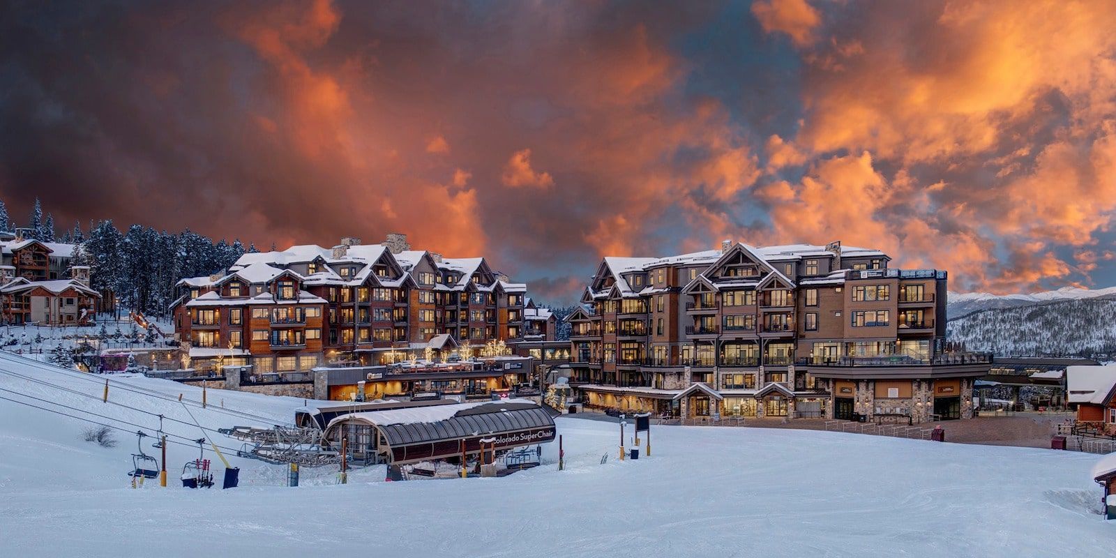 Grand Colorado on peak 8 a snowy ski resort with a sunset in the background.