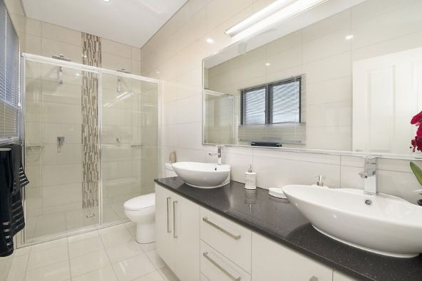 A Bathroom With Two Sinks, a Toilet and a Shower — Precision Shower Screens & Wardrobes In Katherine, NT