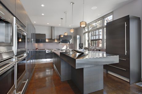 A Kitchen With Stainless Steel Appliances and a Large Island — Precision Shower Screens & Wardrobes In Yarrawonga, NT