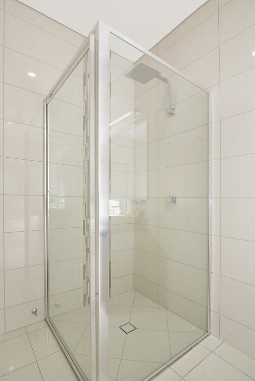 A Bathroom With a Walk in Shower With a Clear Glass Door — Precision Shower Screens & Wardrobes In Yarrawonga, NT