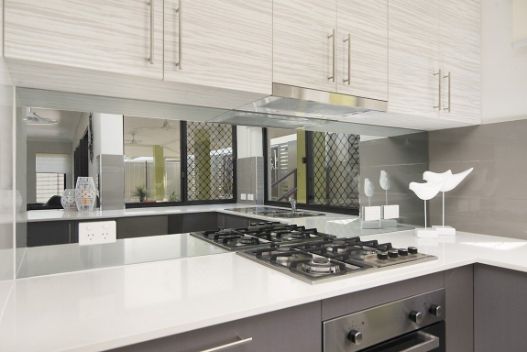 A Kitchen With a Stove Top Oven and a Sink — Precision Shower Screens & Wardrobes In Winnellie, NT