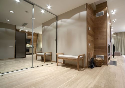 A Hallway With a Bench and a Large Mirror on the Wall — Precision Shower Screens & Wardrobes In Yarrawonga, NT