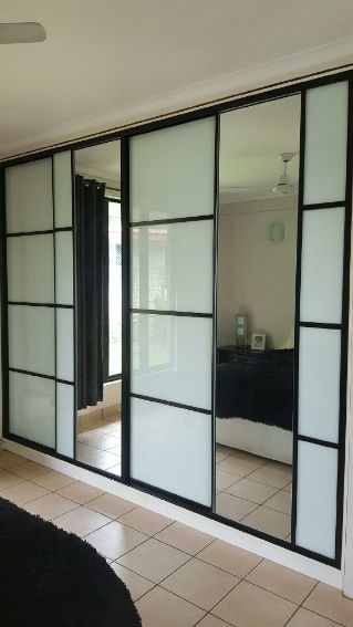 A Room With a Sliding Glass Door Between the Bedroom — Precision Shower Screens & Wardrobes In Yarrawonga, NT