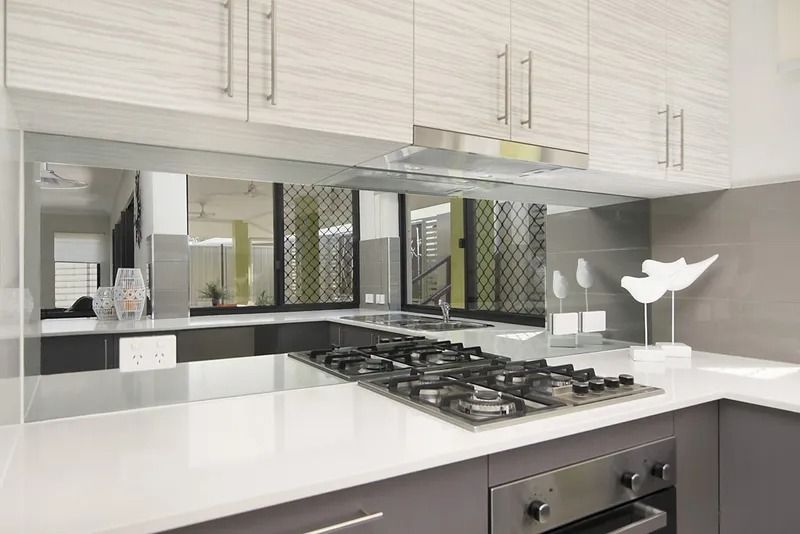 A kitchen with a stove top oven and a sink — Precision Shower Screens & Wardrobes In Yarrawonga, NT