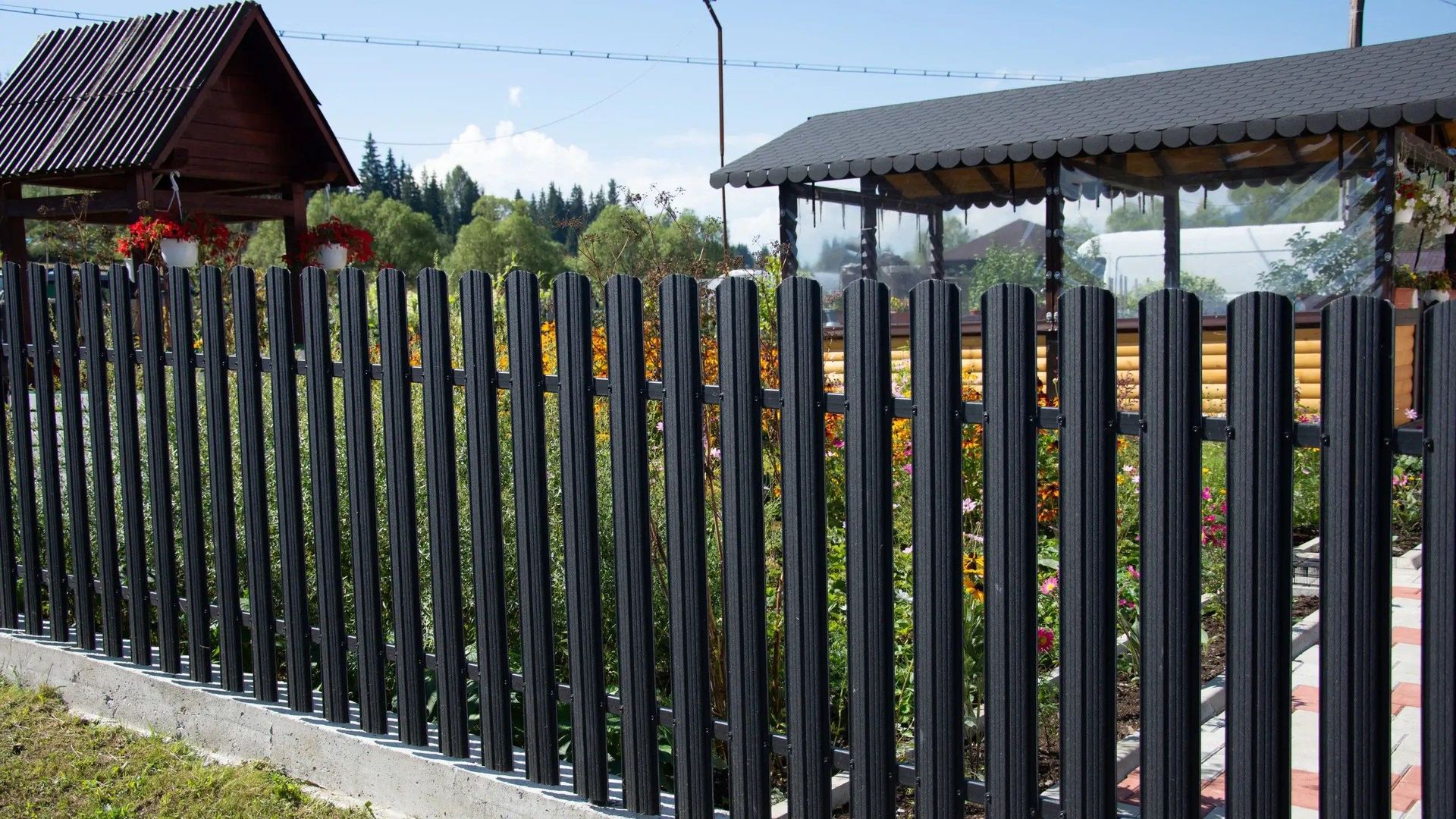 Black metal fence in front of a house.