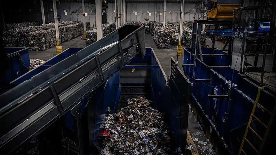 A warehouse filled with lots of trash and a conveyor belt.