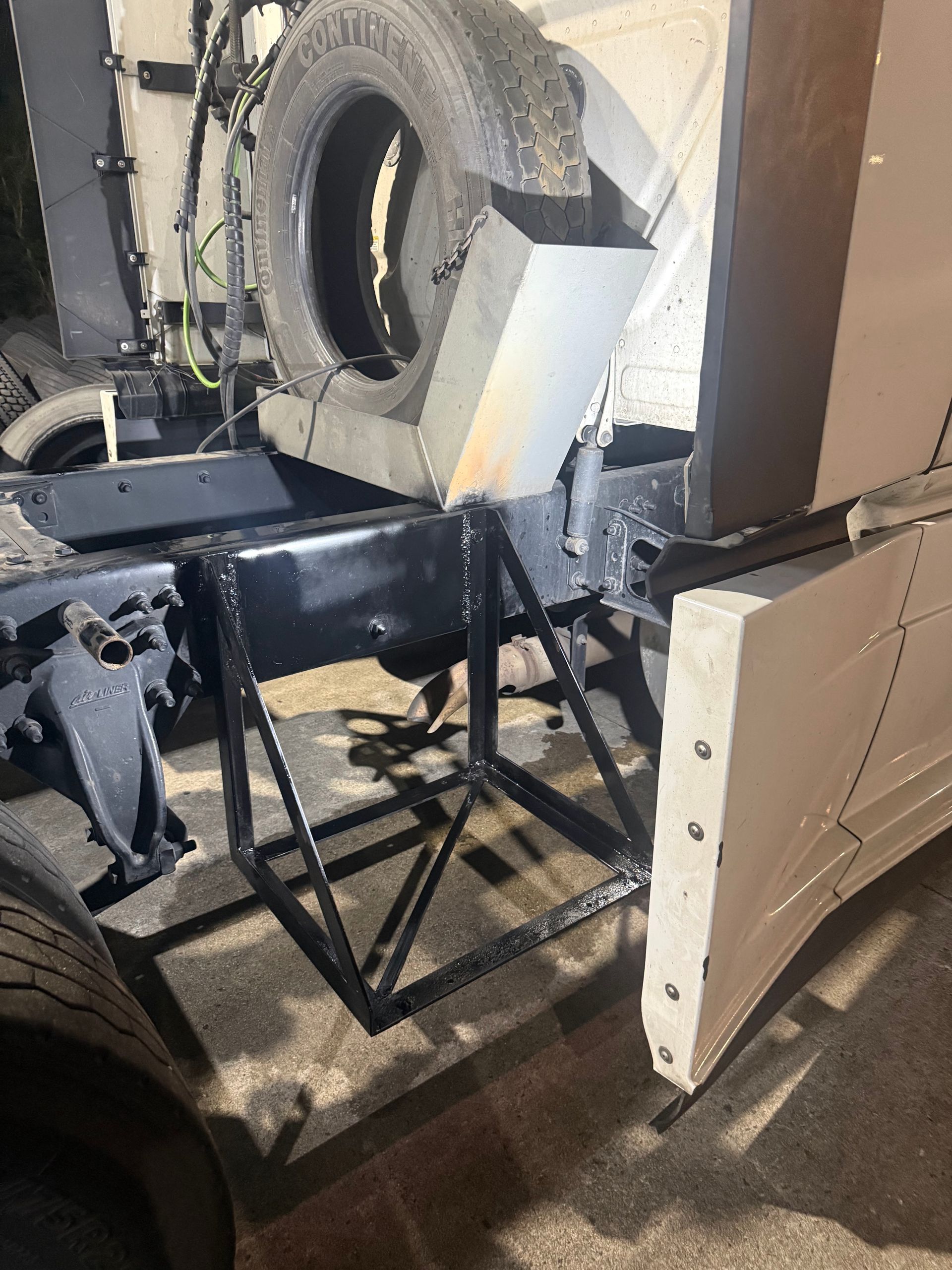 Close-up of a damaged vehicle interior with torn panels and exposed metal framing.