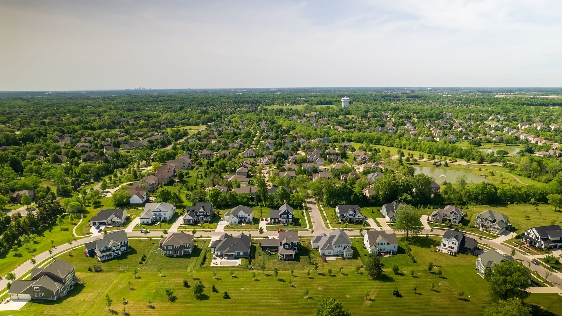 An aerial view of a residential area with lots of houses and trees.